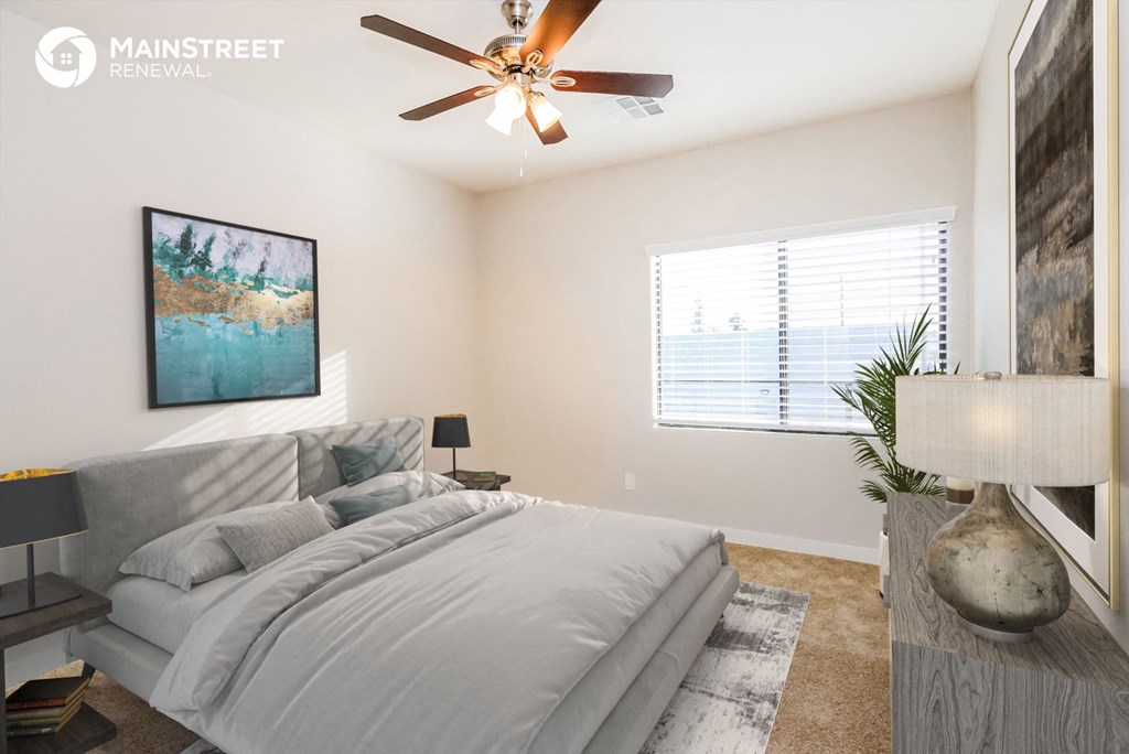 a bedroom with a large bed and a ceiling fan