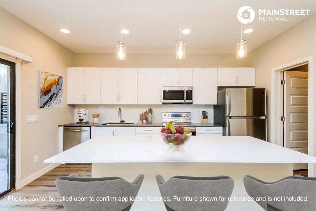 a kitchen with white cabinets and a white counter top
