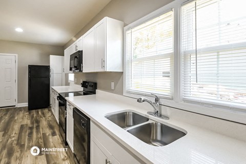a kitchen with a sink and a window