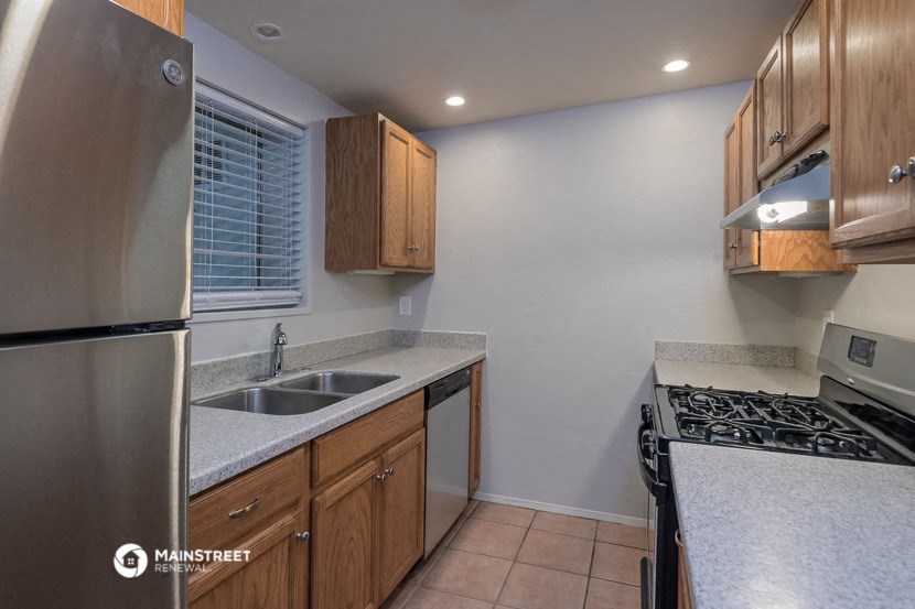 a kitchen with a stove sink and refrigerator and