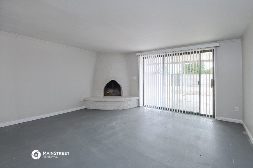 a living room with a fireplace and a sliding glass door