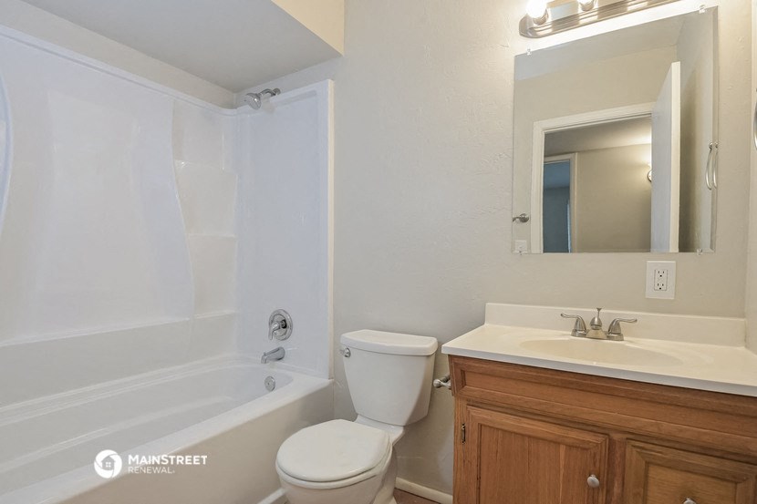 a bathroom with a sink toilet and a tub
