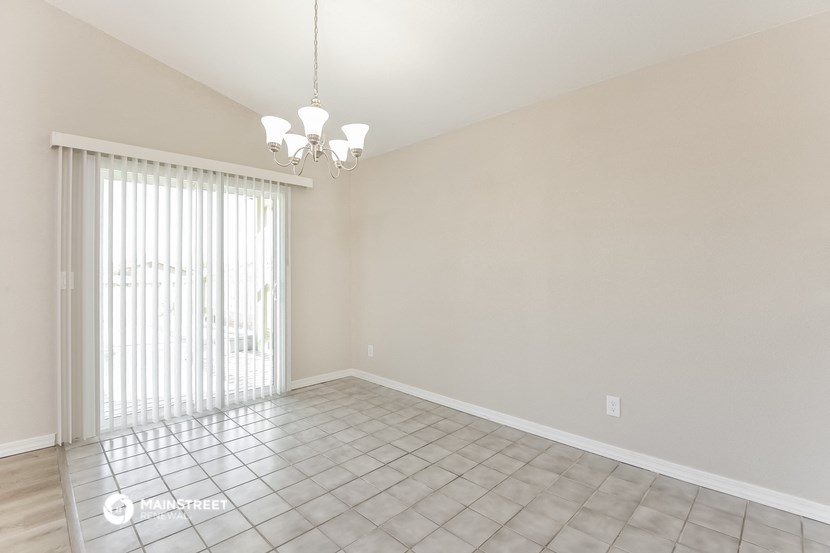 an empty living room with a sliding glass door to a patio