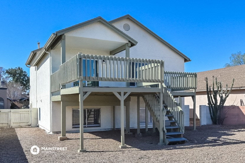 a white house with a deck on top of it