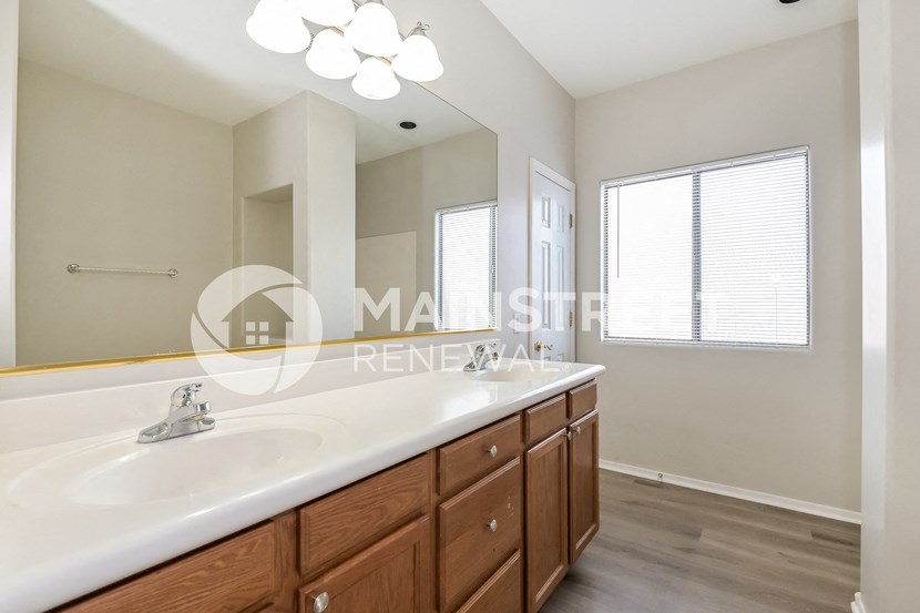 a bathroom with a large sink and a large mirror