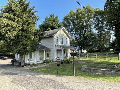 an old with a yard and trees