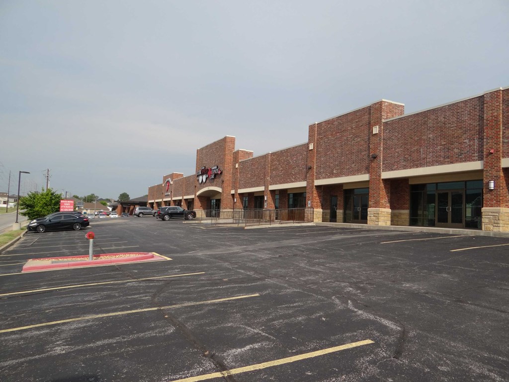 a parking lot in front of a brick building