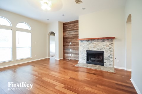 a living room with a fireplace and a wooden floor