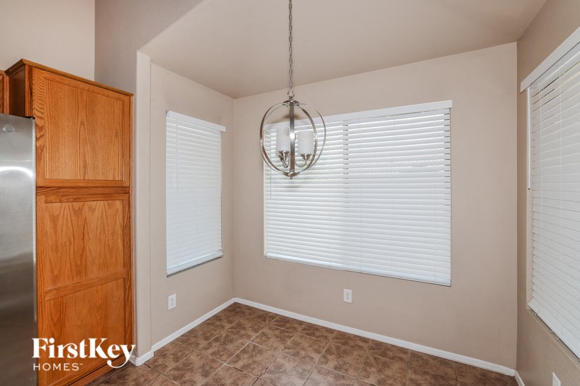 a dining room with a large window and a chandelier