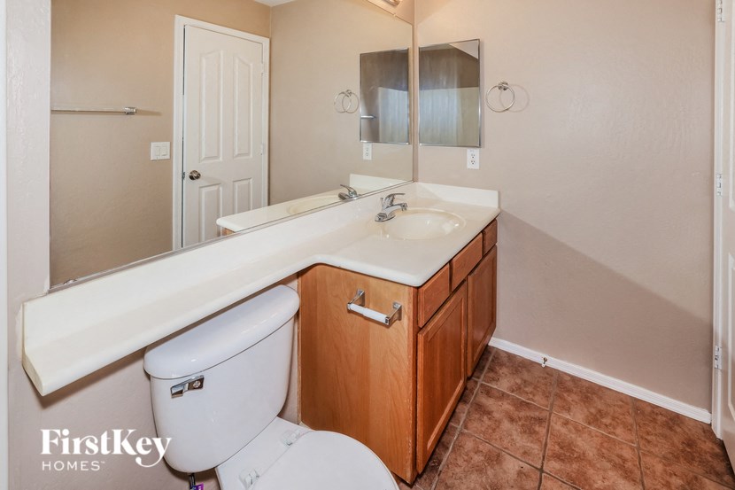 a bathroom with a toilet and a sink and a mirror