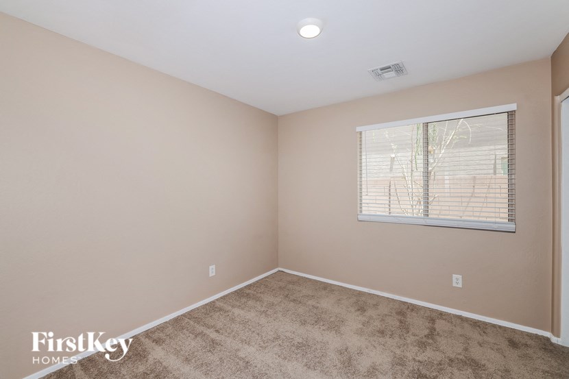 the living room of a home with carpet and a window