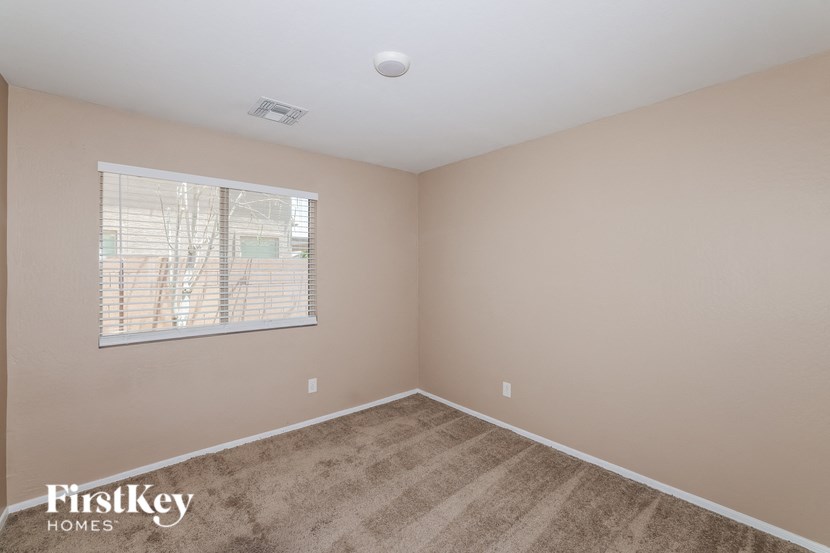 the living room of a home with a carpeted floor and a window
