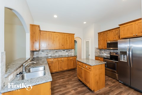 A kitchen with wooden cabinets and stainless steel appliances.