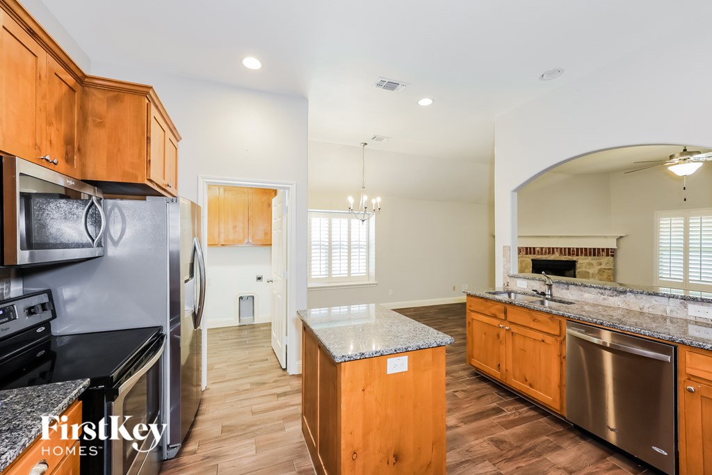 A kitchen with wooden cabinets and stainless steel appliances.