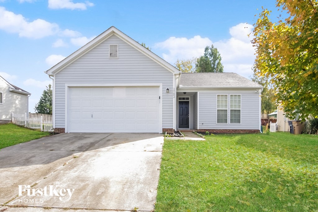 A two-story house with a garage is for sale.