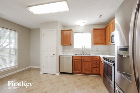 A kitchen with wooden cabinets and stainless steel appliances.