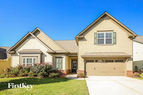 A house with a garage and a driveway is for sale.