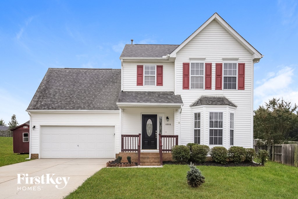 a white house with red shutters and a porch