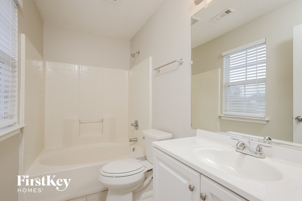 a bathroom with a sink toilet and a bath tub