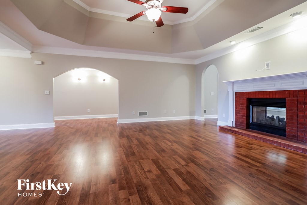 a living room with a fireplace and a hard wood floor