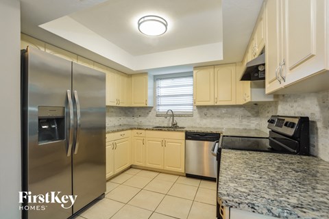 a kitchen with granite counter tops and stainless steel appliances