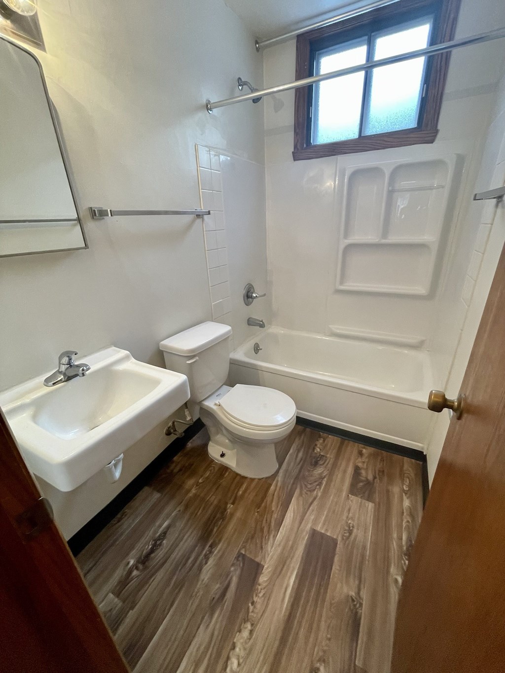 a bathroom with a toilet and a sink and a bath tub