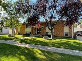 a brick building with trees in front of it