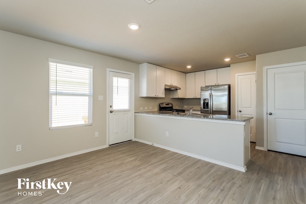 A kitchen area with a refrigerator, microwave, and oven.