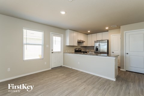 A kitchen area with a refrigerator, microwave, and oven.