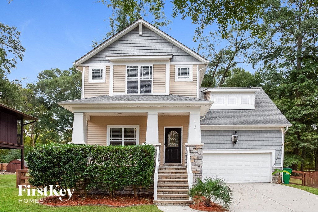 a white house with a porch and a black door