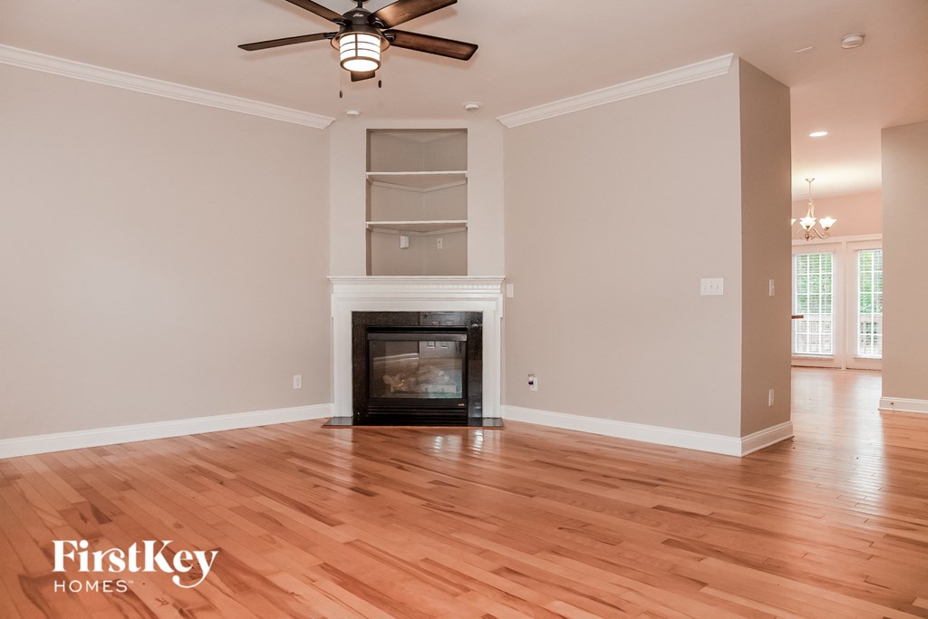 the living room has a fireplace and hardwood floors