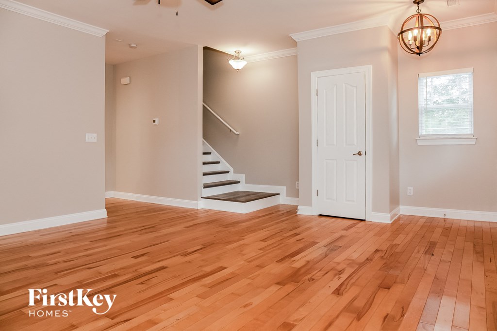 a living room with a hardwood floor and a white door