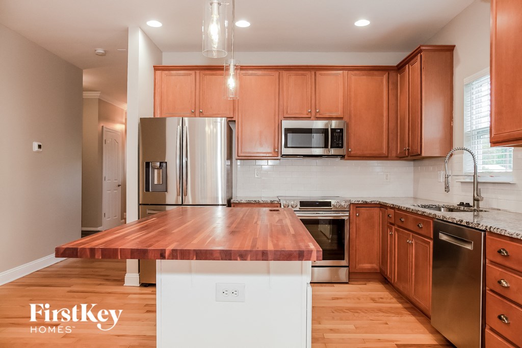 a kitchen with wooden cabinets and stainless steel appliances