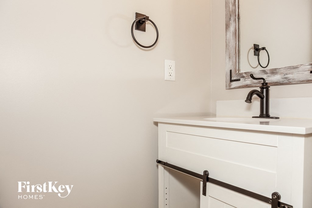 a small bathroom with a sink and a mirror