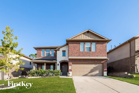 a house with a driveway and a garage door