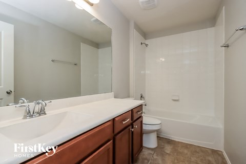 a bathroom with a sink and a toilet and a bath tub
