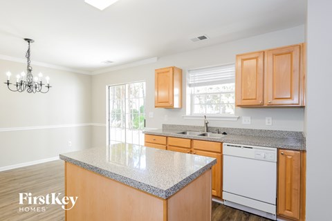 A kitchen with wooden cabinets and a white dishwasher.