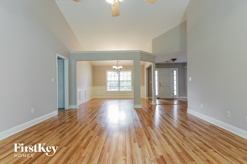the living room and dining room of an empty house