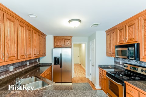 a kitchen with wooden cabinets and stainless steel appliances