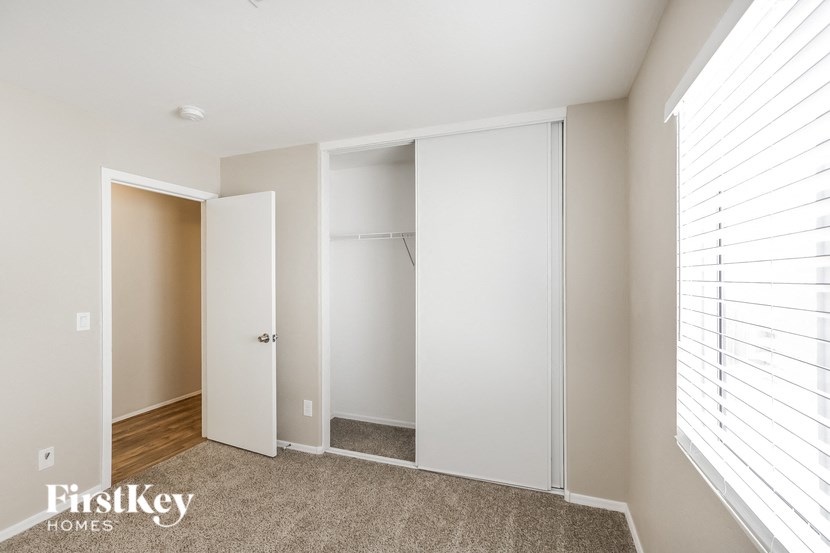 a master bedroom with a closet and a door to a walk in closet