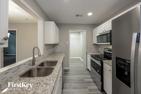 a kitchen with granite counter tops and stainless steel appliances