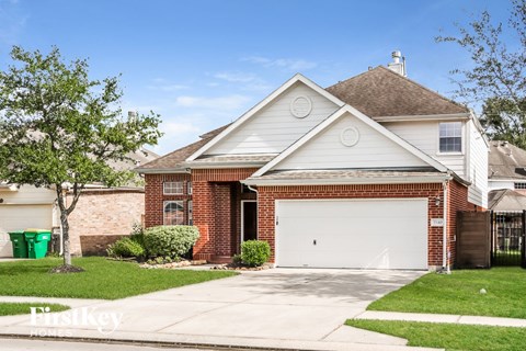 a brick house with a white garage door