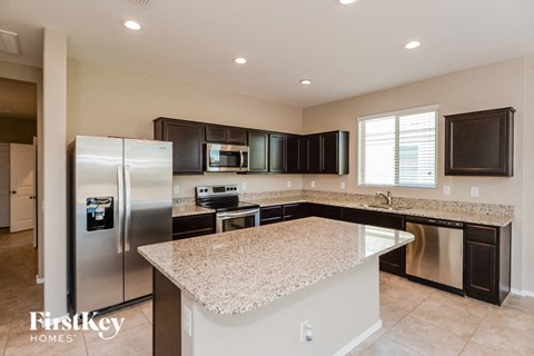 a kitchen with granite counter tops and stainless steel appliances