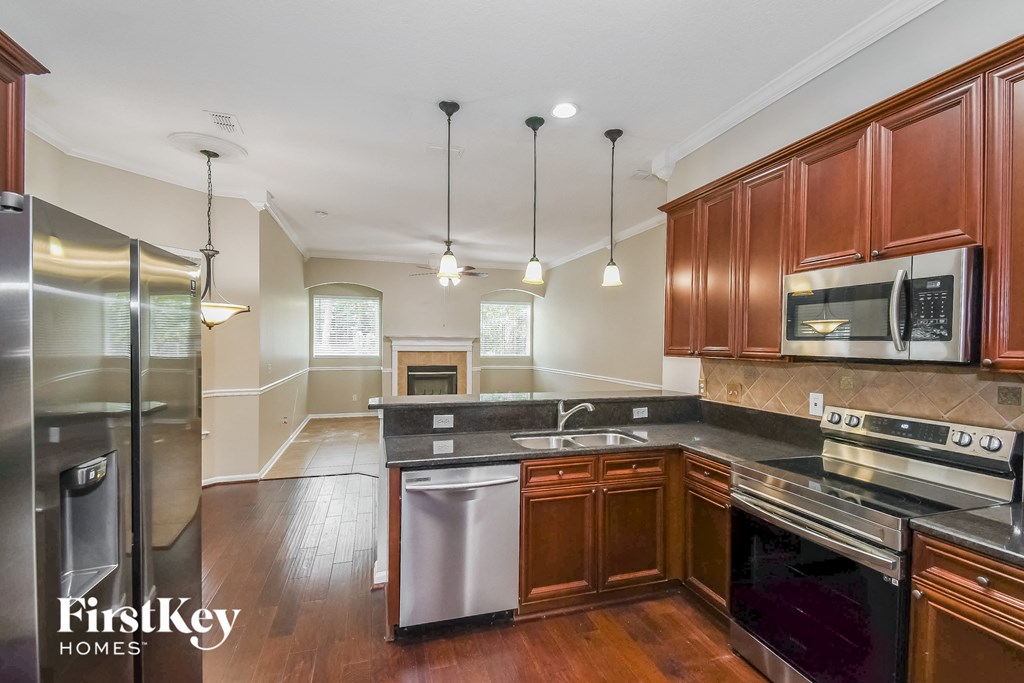 a kitchen with wooden cabinets and stainless steel appliances