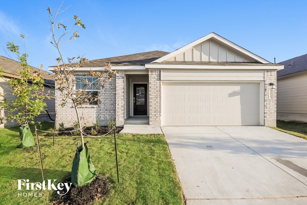 A house with a garage door is for sale by FirstKey Homes.