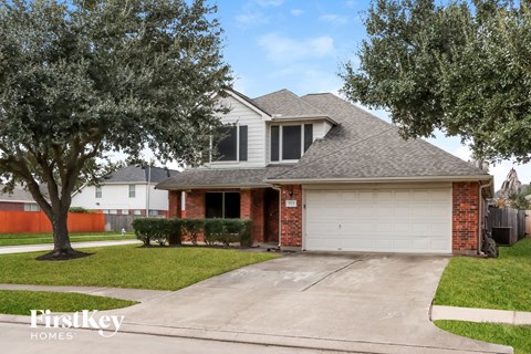 a house with a white garage door and a tree