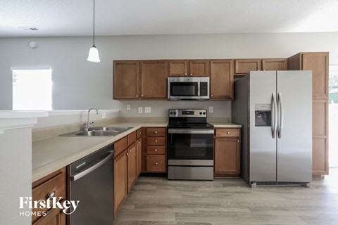 A kitchen with wooden cabinets and stainless steel appliances.