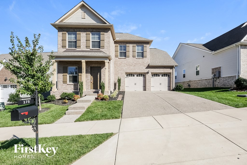 a house with a driveway and a parking meter in front of it