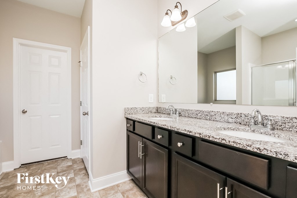 a bathroom with two sinks and a large mirror
