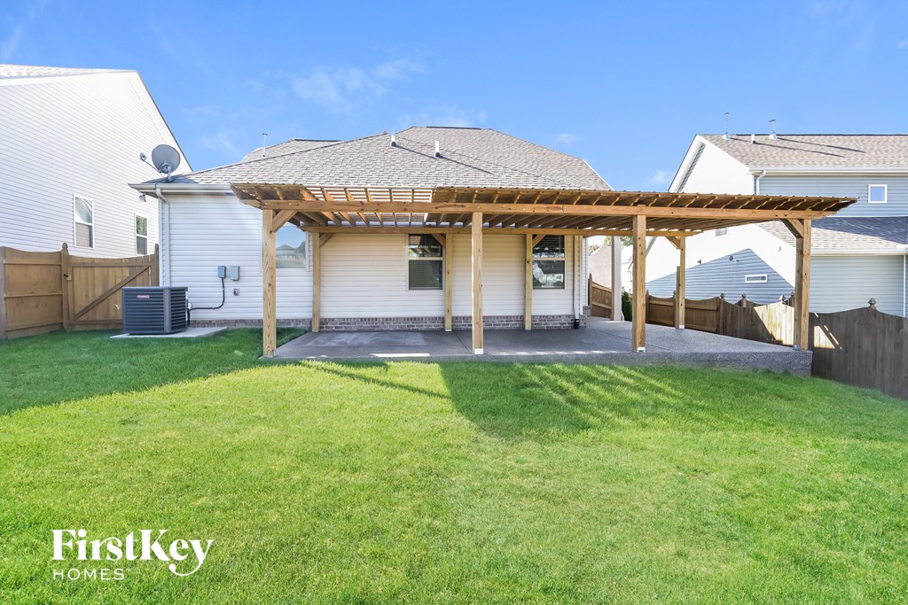a backyard with a patio and a pergola